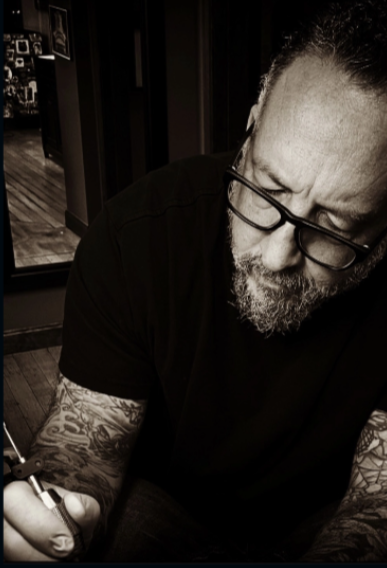 Image of Tony Baris, owner of tattoo shop Cosmic Sea Tattoo in Portland,Maine